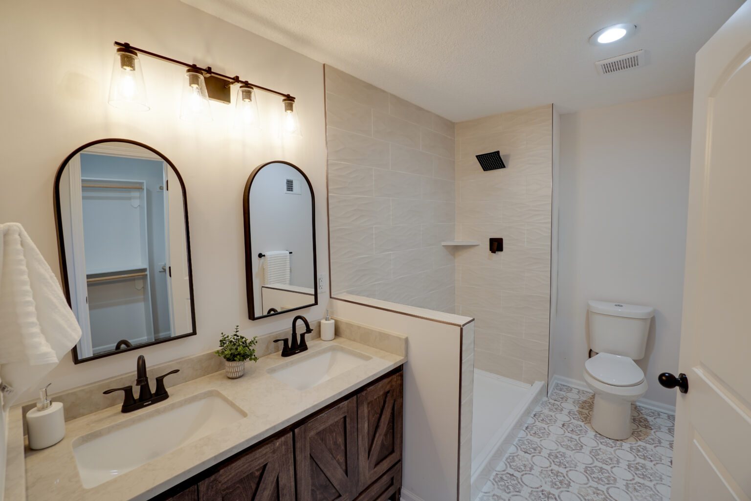 a bathroom with two sinks, mirrors, and white walls