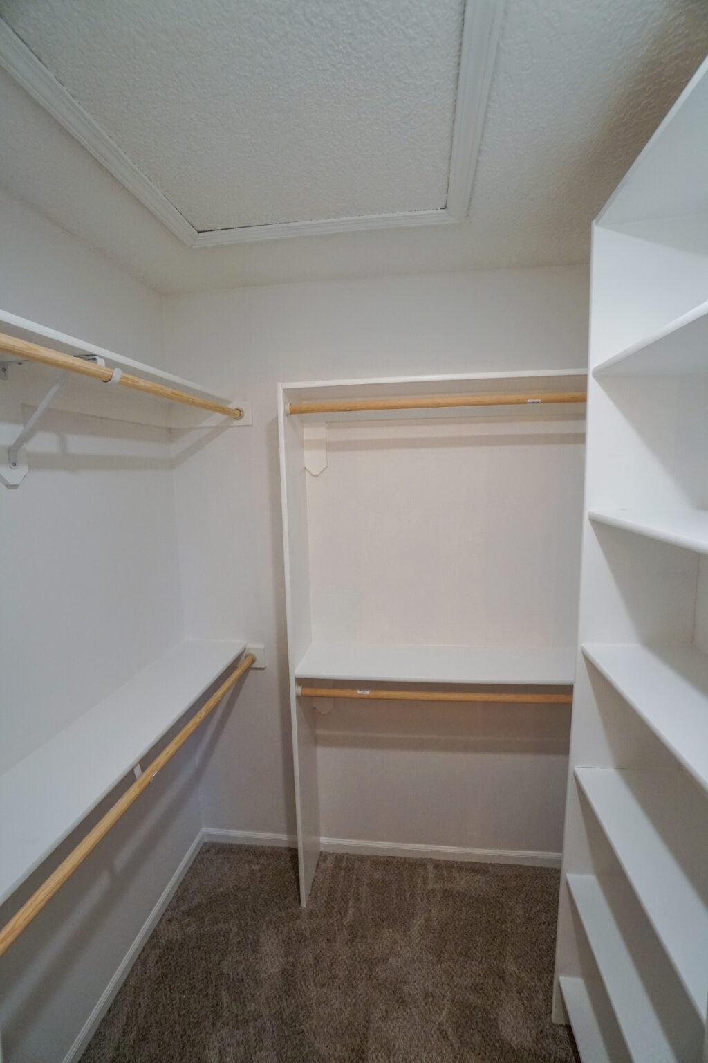 a storage room with white walls and shelves