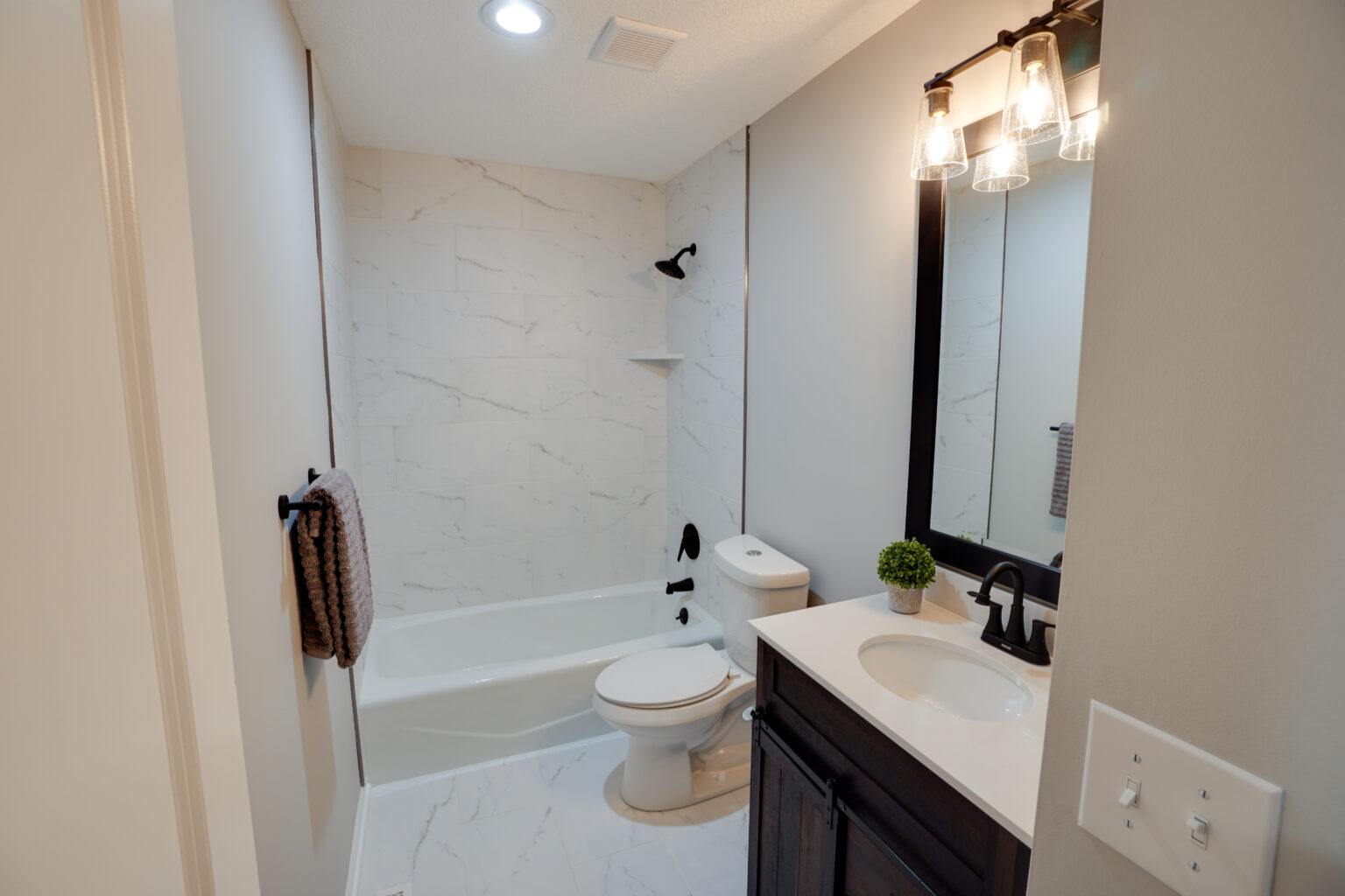 a white bathroom with a shower and bathtub, toilet, and sink