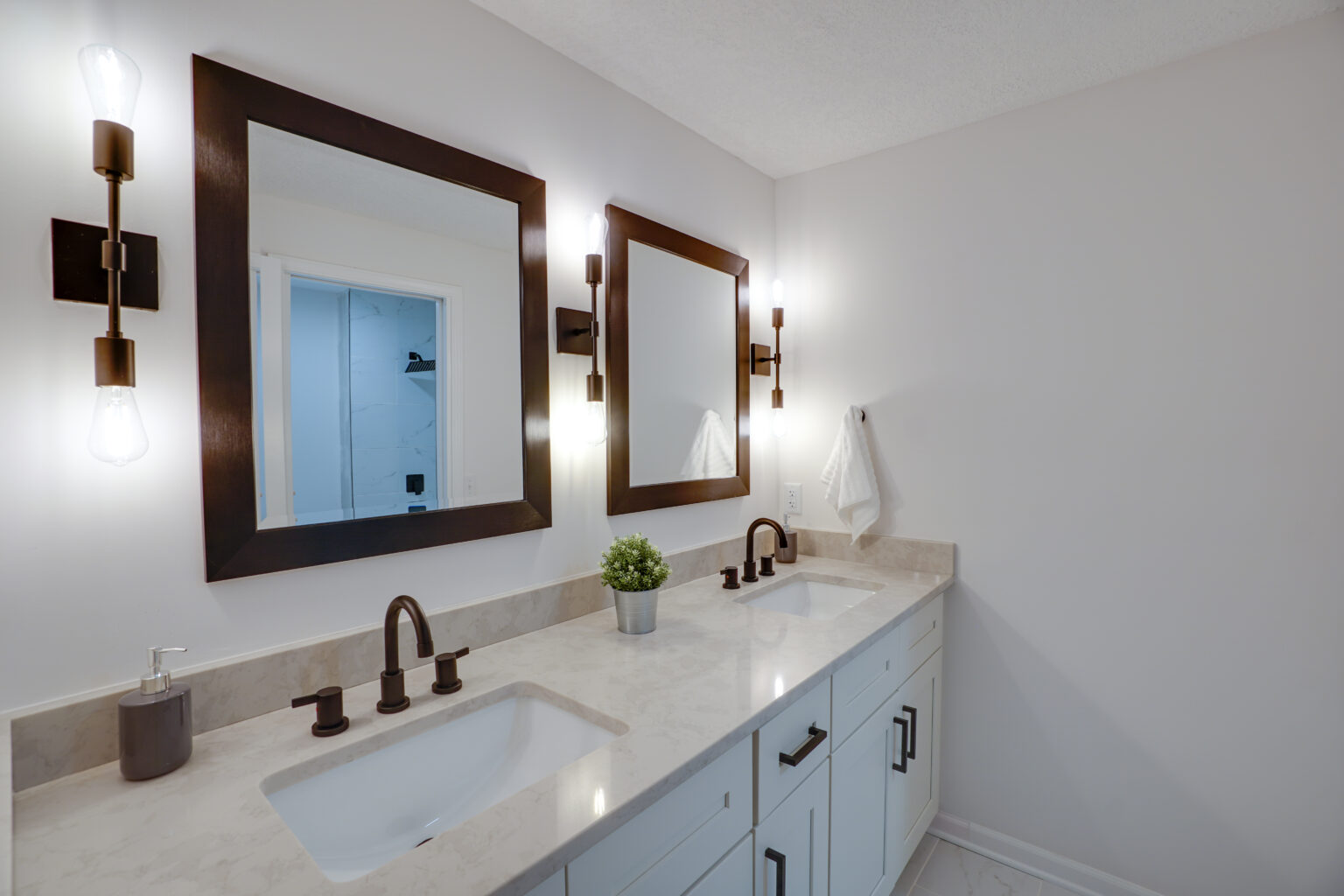 two bathroom sinks with square mirrors above