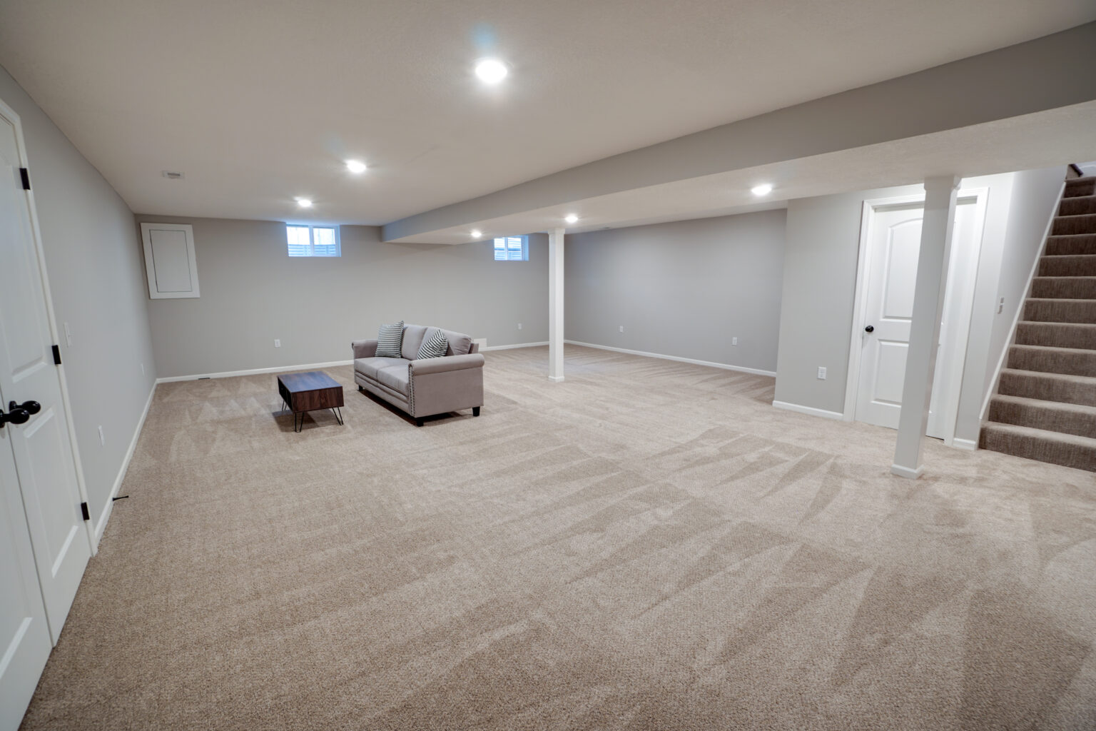 a spacious room with a sofa and a coffee table