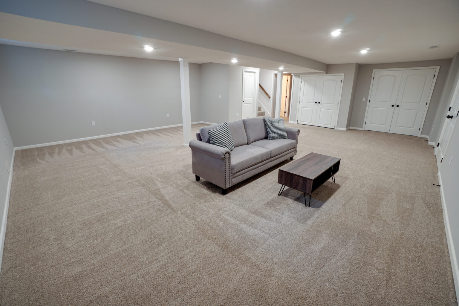 a sofa and a coffee table in a spacious room