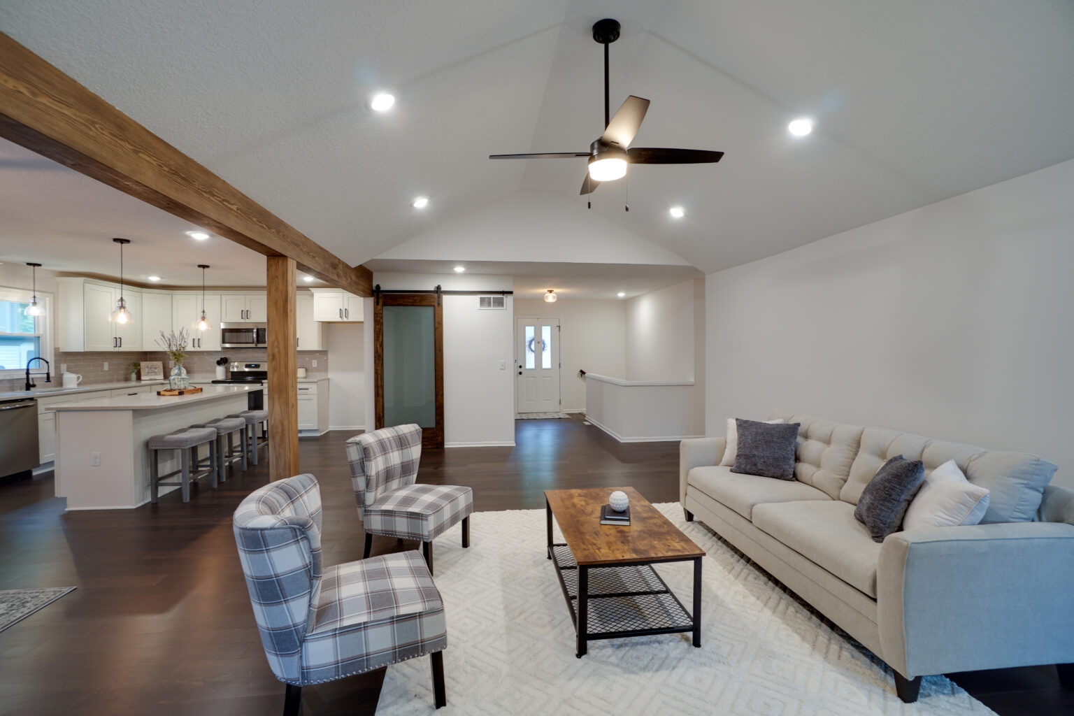 a living room with a sofa, coffee table, and two lounge chairs