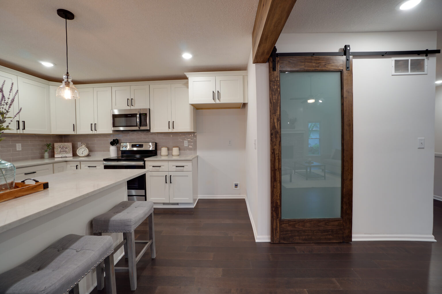 a kitchen with white counters and modern appliances