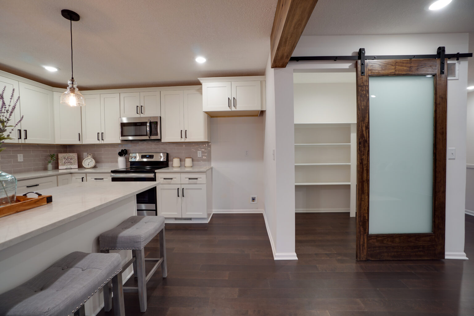 a white kitchen next to a pantry